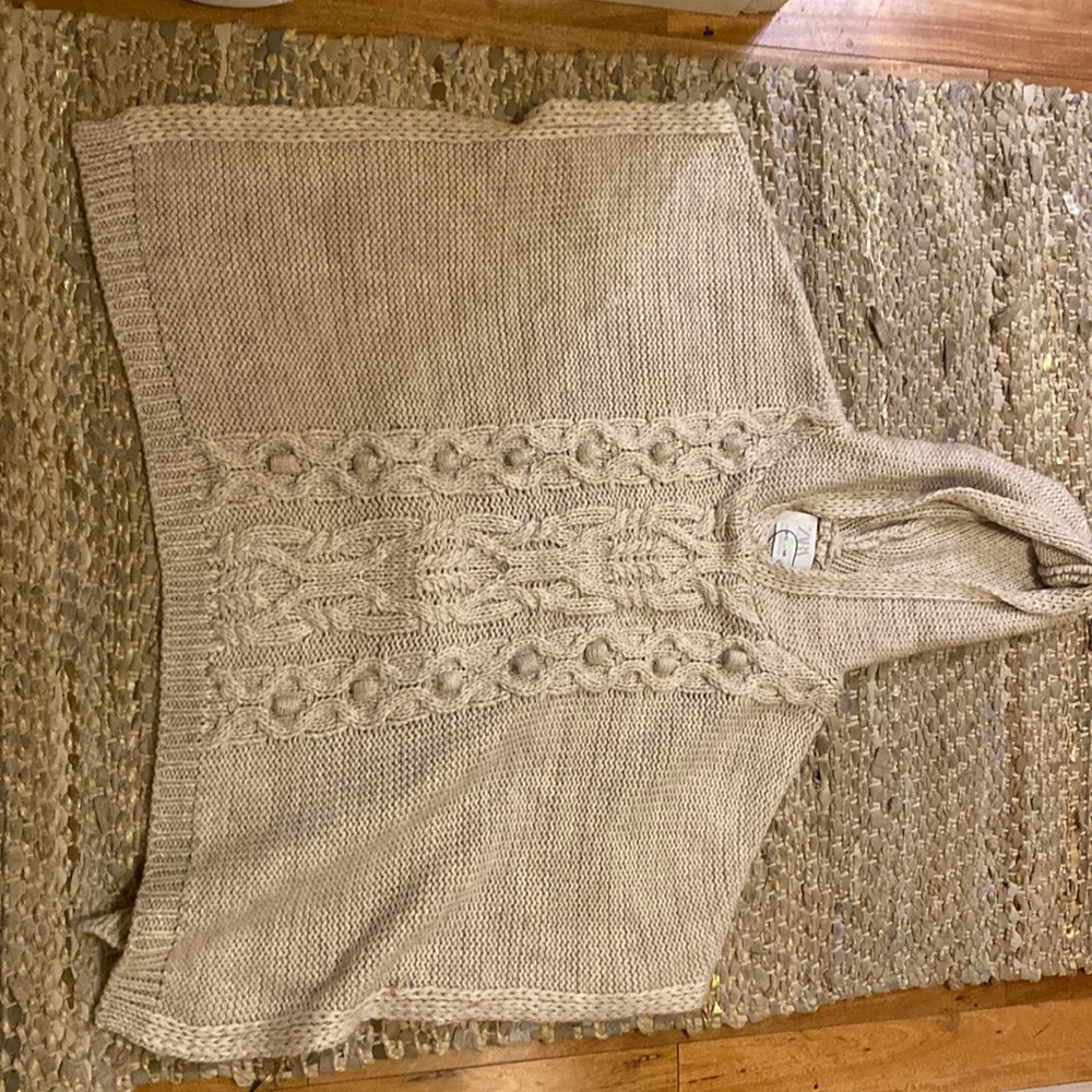 This sleek beige poncho for kids is perfect in any climate and basically new!!!!